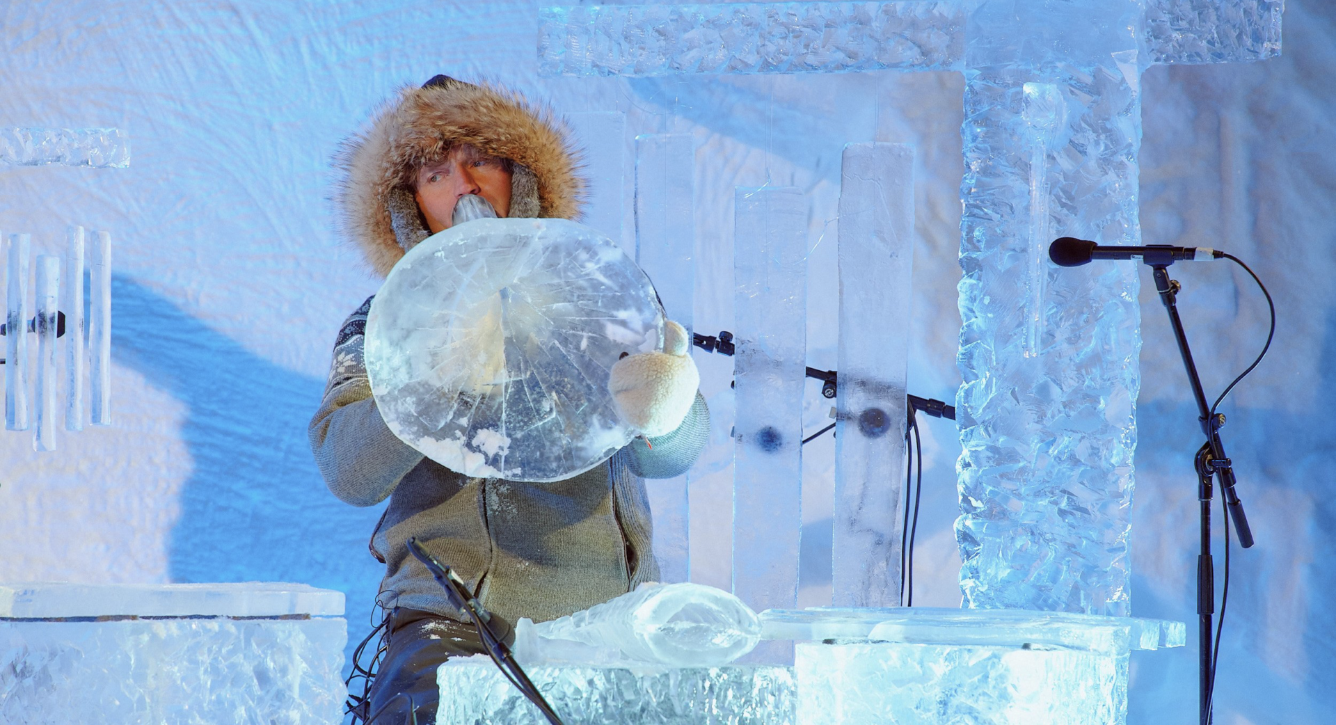 Instrument made of ice (an ice horn) being played by a musician in a parka