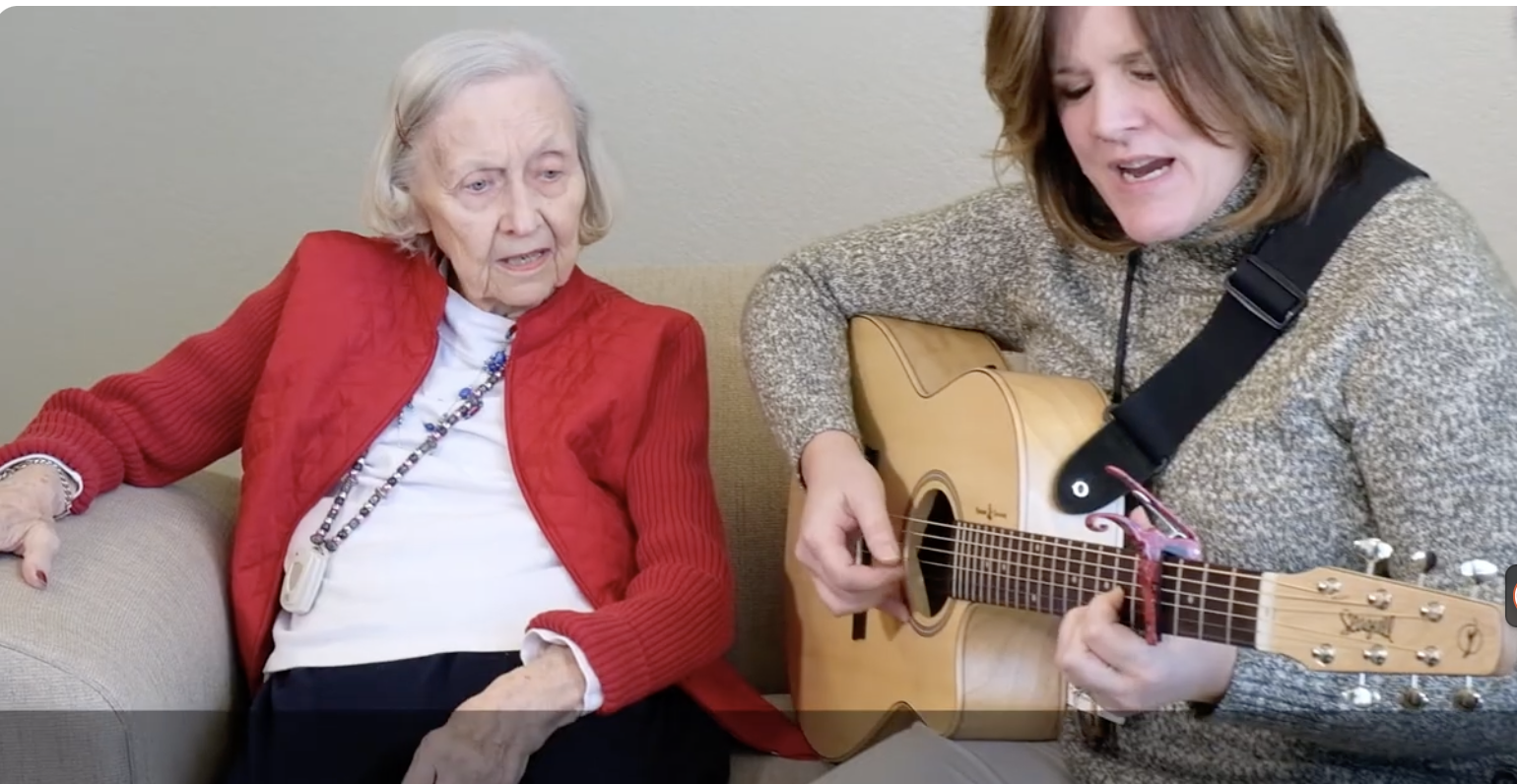 Joan and her music therapist Roxie singing together.