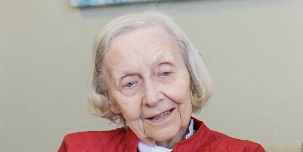 Picture of Joan smiling. She has dementia and loves to sing